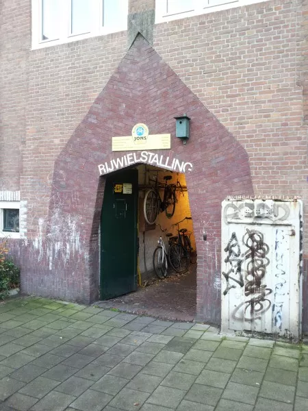 Afbeelding uit: december 2013. Mesdagstraat. Ingang van de fietsenstalling, die in 1952 door Gulden werd ontworpen. Rechts een oude GE-kabelkast, ontworpen door PW-architect Marnette.