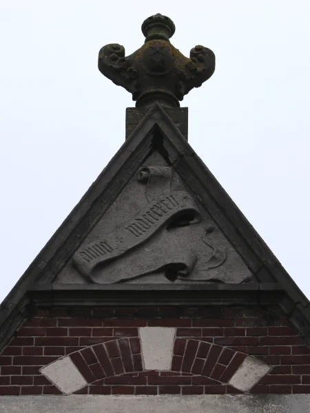 Afbeelding uit: januari 2024. Centrale geveltop. Geheel boven een vaas met de drie andreaskruizen, daaronder een driehoekig vlak waarin een banderol met de tekst "Anno MDCCCXCII".