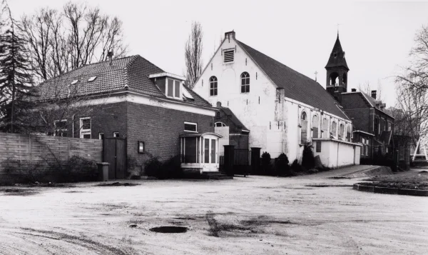 Afbeelding uit: maart 1994. Het witte gebouw diende van 1835 tot 1935 als kerk van de parochie Buitenveldert. Daarna werd het de kapel van de r.-k. begraafplaats Buitenveldert. In 1994 werd het afgebroken.
Bron afbeelding: SAA, bestand 010122002273.